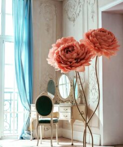 image of three peach flowers on a metal base