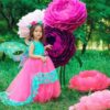 Mini giant flowers in lilac, dark purple, and fuchsia displayed outdoors for kids’ party decor in Toronto.