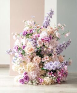 Pastel pink, lavender, and cream silk floral arrangement with roses, hydrangeas, and delphiniums