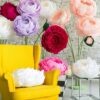 Oversized handmade flowers in vibrant colors with yellow chair setup by Magic Flowers Event Rentals decor rentals Woodbridge
