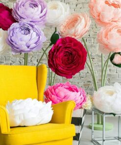 Oversized handmade flowers in vibrant colors with yellow chair setup by Magic Flowers Event Rentals decor rentals Woodbridge