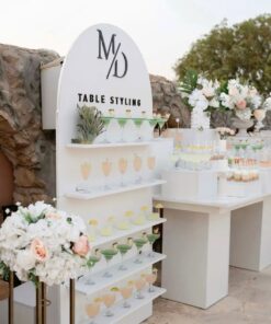 Cocktail display wall decorated with florals for event décor rentals in Newmarket