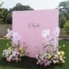 Elegant pink backdrop with floral arrangements for event decor rentals in Oakville, Ontario