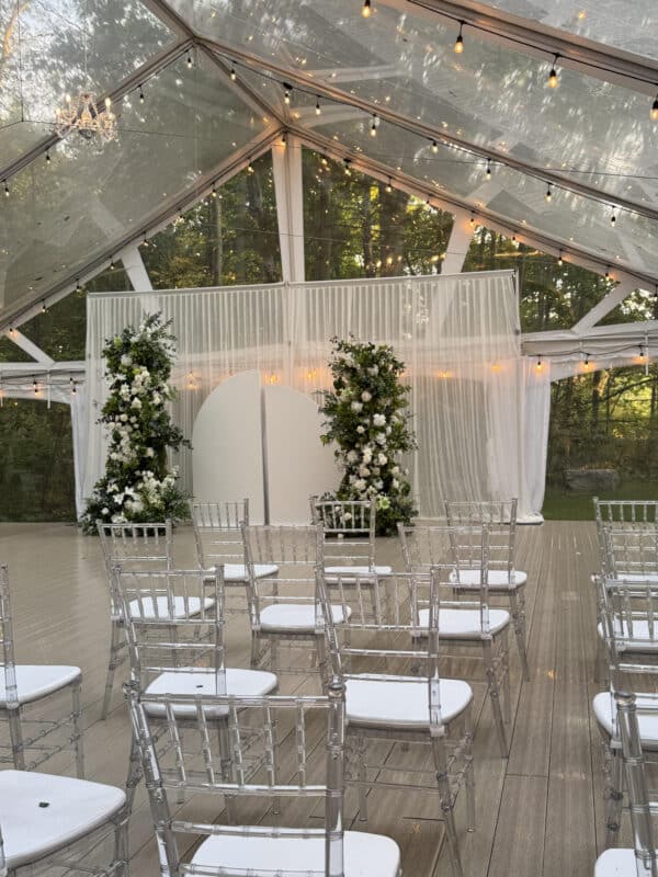Elegant wedding reception decor with floral arrangements and modern backdrop rentals in Ajax