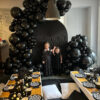 Halloween family picnic setup in Toronto with black ripple backdrop and balloon decor