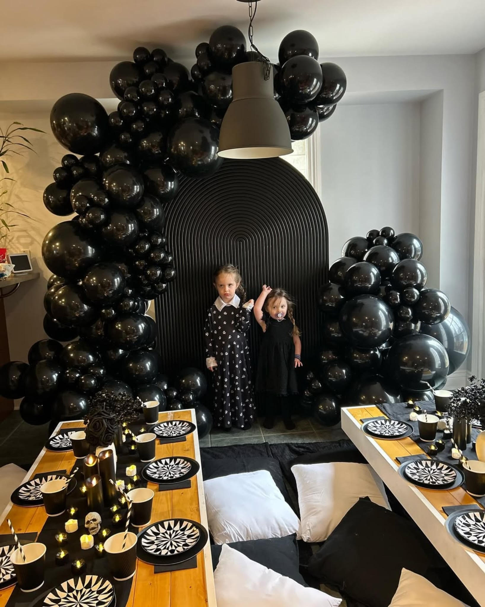 Halloween family picnic setup in Toronto with black ripple backdrop and balloon decor