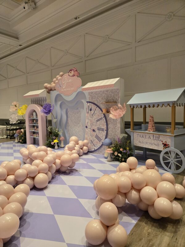 Whimsical giant standing flowers garden and custom 1st birthday decor setup at the Embassy Grand Convention Centre in Brampton.