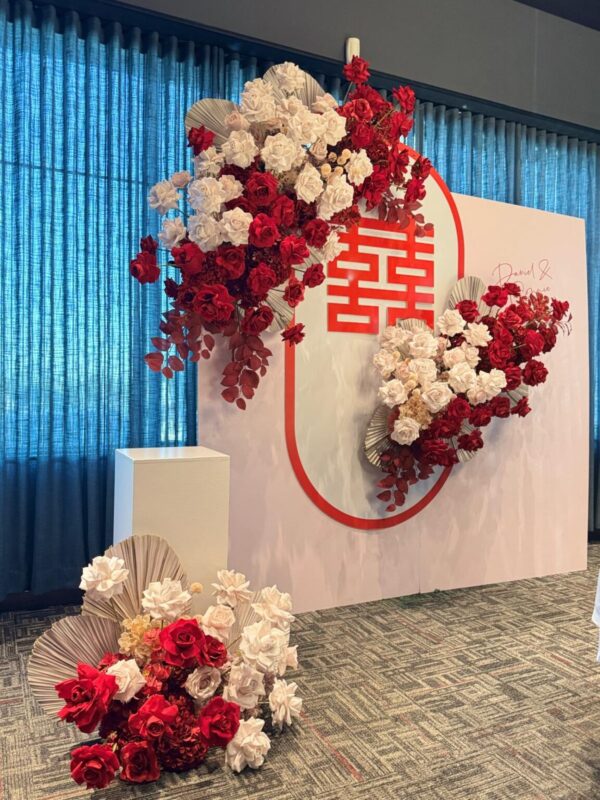 Double Happiness square backdrop wall with flower cascades and cake stand for a Chinese wedding