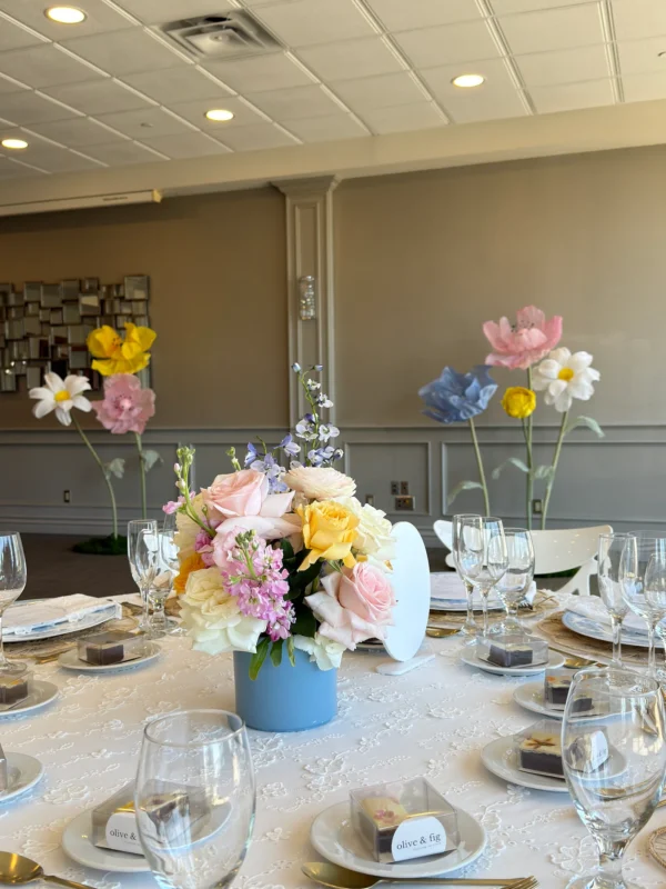 Pastel table setting with custom oversized silk flowers in the background for a luxury children's birthday party at Copper Creek Golf Club in Kleinburg, Vaughan.