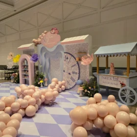 Oversized decorative artificial flowers in pastel purple, yellow, and peach.