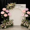 Pastel giant flower baby shower backdrop with Mama in Bloom sign and elegant white arch.