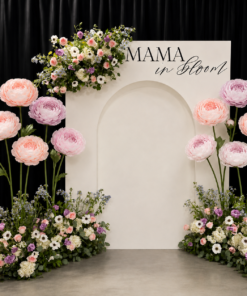 Pastel giant flower baby shower backdrop with Mama in Bloom sign and elegant white arch.