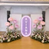 Enchanted Bloom Package with personalized name, giant pastel flowers, and lush pink, purple, and white floral arrangements.