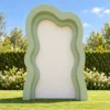 Sage green 3D wavy backdrop with a plain ivory centre panel, measuring 7 ft high by 5.5 ft wide, for weddings, showers, birthdays, and event photo displays.