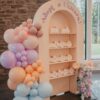 Arched Treat Wall Backdrop with built-in shelves for party favours, desserts, gifts, and event displays.