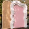 Boho wavy backdrop package featuring a natural rattan arch, white layered wavy arch, and blush pink centre panel for bridal showers, birthdays, baby showers, and weddings.