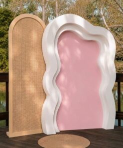 Boho wavy backdrop package featuring a natural rattan arch, white layered wavy arch, and blush pink centre panel for bridal showers, birthdays, baby showers, and weddings.