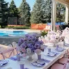 Pastel floral centrepiece in lavender, blush pink and white with roses and hydrangeas, styled in an elegant pedestal vase for a butterfly-themed kids’ party.
