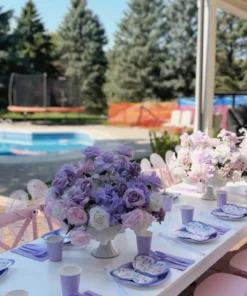 Pastel floral centrepiece in lavender, blush pink and white with roses and hydrangeas, styled in an elegant pedestal vase for a butterfly-themed kids’ party.