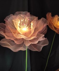 Giant Light-Up Flowers with warm glowing lights on a tall green stem for weddings and corporate event decor.