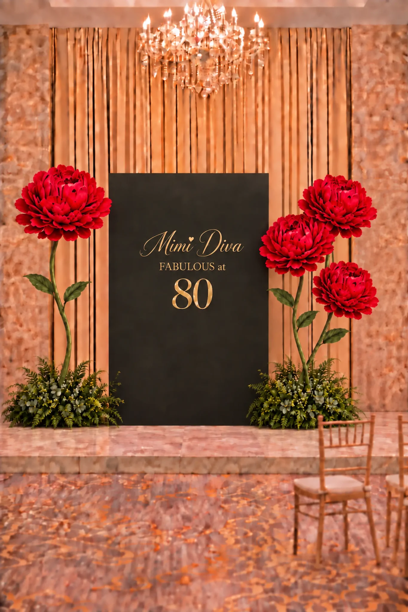Black and gold birthday backdrop with custom gold lettering, oversized red flowers, tall green stems, and lush greenery arrangements for an elegant celebration.