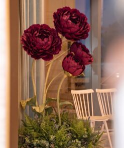 Burgundy Giant Bloom Garden on tall sculptural stems with green leaves and a lush botanical base of ferns, eucalyptus-style greenery, and foliage.